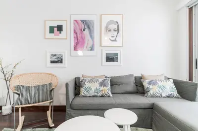 a living room with a gray couch and pictures on the wall at Santa Catarina II by An Island Apart in Funchal