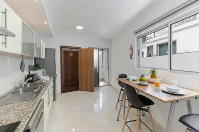 a kitchen and dining room with a table and chairs at Santa Catarina II by An Island Apart in Funchal