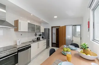 a kitchen with a table with a bowl of fruit on it at Santa Catarina II by An Island Apart in Funchal