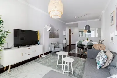 a living room with a couch and a dining room at Santa Catarina II by An Island Apart in Funchal