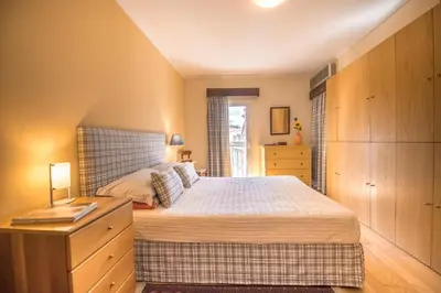 a bedroom with a bed and a dresser and a window at Funchal Arcadas Apartment by MLV in Funchal
