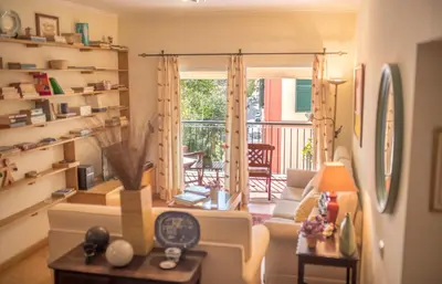 a living room with a couch and a balcony at Funchal Arcadas Apartment by MLV in Funchal
