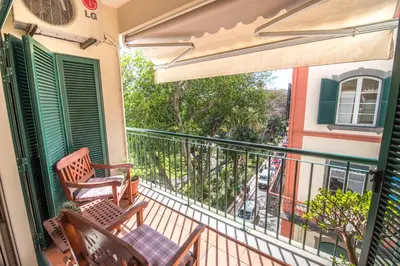 a balcony with chairs and a view of a building at Funchal Arcadas Apartment by MLV in Funchal