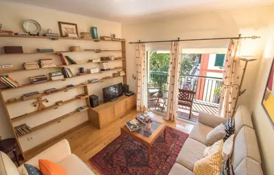 a living room with shelves and a couch and a tv at Funchal Arcadas Apartment by MLV in Funchal