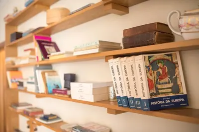 a book shelf with books on it at Funchal Arcadas Apartment by MLV in Funchal