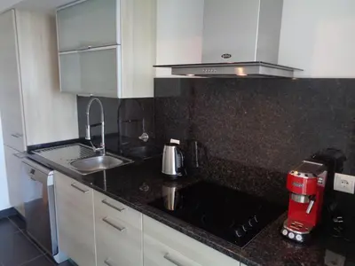 a kitchen with a sink and a counter top at Paradisus Stylish Family Living in a 3-Bedroom Condo with Pool in Caniço
