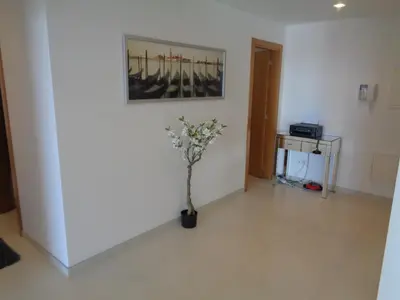 a room with a vase with flowers in it at Paradisus Stylish Family Living in a 3-Bedroom Condo with Pool in Caniço