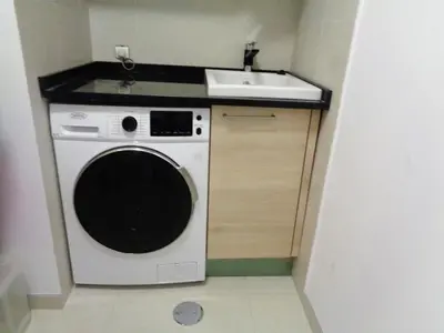 a small kitchen with a sink and a washing machine at Paradisus Stylish Family Living in a 3-Bedroom Condo with Pool in Caniço