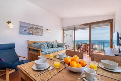 a living room with a table with oranges on it at H&H seaview in Luz
