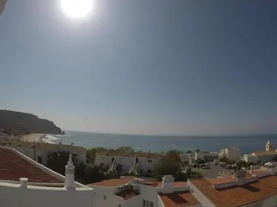 a view of the ocean from the roofs of buildings at H&H seaview in Luz