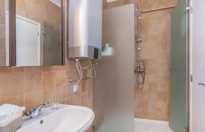 a bathroom with a sink and a shower at H&H seaview in Luz
