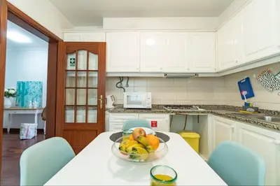 a kitchen with a table with a bowl of fruit on it at Apartamento Netos - By WeHost in Funchal