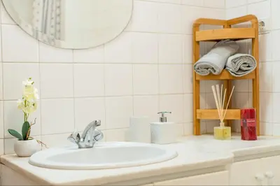 a bathroom counter with a sink and a mirror at Apartamento Netos - By WeHost in Funchal