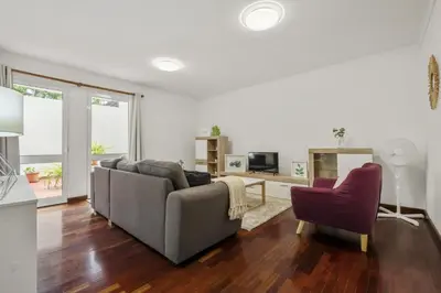 a living room with a couch and a chair at Apartamento Netos - By WeHost in Funchal