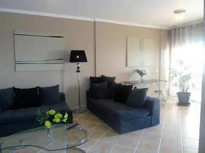 a living room with two couches and a table at Oceanic Apartment in Caniço