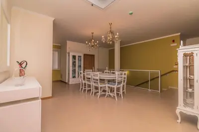 a dining room with a table and chairs at Pink House - Tabua (Ribeira Brava) in Ribeira Brava