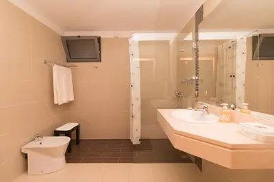 a bathroom with a sink and a toilet and a shower at Pink House - Tabua (Ribeira Brava) in Ribeira Brava