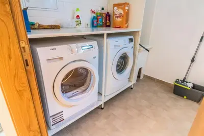 a laundry room with a washer and dryer at Pink House - Tabua (Ribeira Brava) in Ribeira Brava
