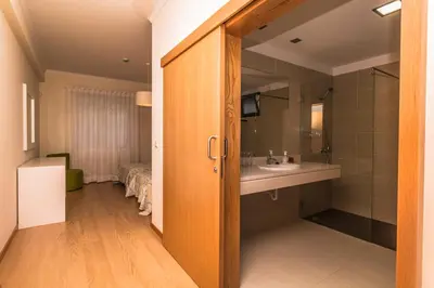 a bathroom with a sink and a mirror at Pink House - Tabua (Ribeira Brava) in Ribeira Brava