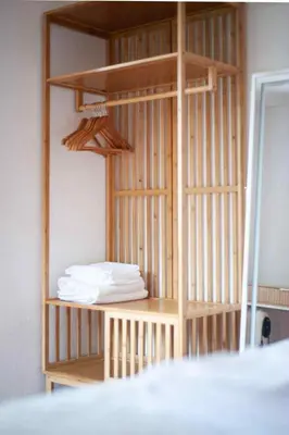 a wooden book shelf with white towels on it at Casa Reis in Santana