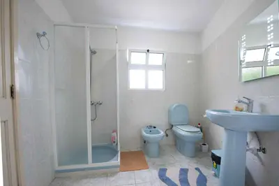 a bathroom with a shower and a toilet and a sink at Casa Reis in Santana