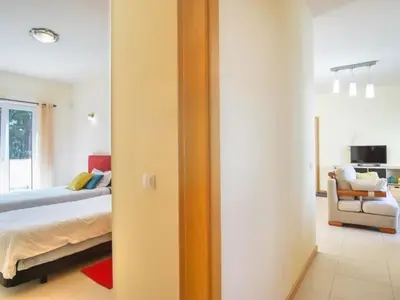 a bedroom with a bed and a living room at Casa Aromas do Mar, Burgau in Burgau