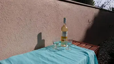 a bottle of wine sitting on a table with glasses at Casa Aromas do Mar, Burgau in Burgau