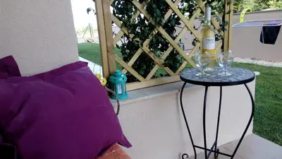 a bottle of wine on a table next to a window at Casa Aromas do Mar, Burgau in Burgau