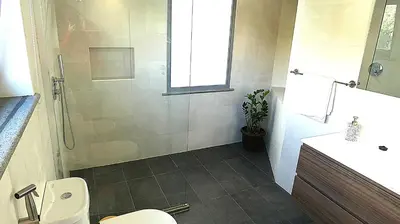 a bathroom with a shower and a toilet and a sink at Madeira Serenity Cottage in Funchal