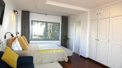a bedroom with a bed and a window at Madeira Serenity Cottage in Funchal