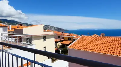 a view of a city from a balcony at Madeira Serenity Cottage in Funchal