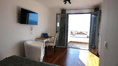 a room with a desk with a laptop on it at Madeira Serenity Cottage in Funchal