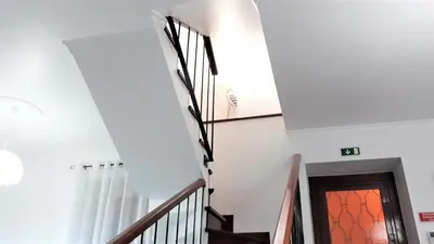 a staircase in a house with white walls at Casa da Avó Irene in Funchal