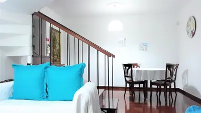 a room with a bed and a table and chairs at Casa da Avó Irene in Funchal