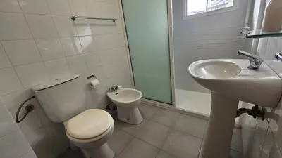 a white bathroom with a toilet and a sink at Santa Luzia Apartment in Funchal