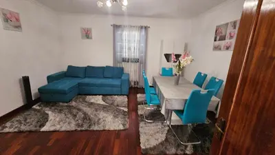 a living room with a blue couch and a table at Santa Luzia Apartment in Funchal