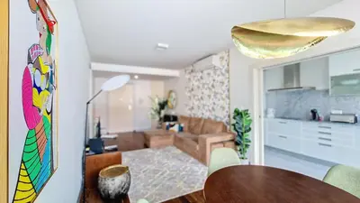 a dining room and living room with a table at Upscales by LovelyStay - private parking in Funchal