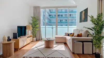 a living room with white furniture and a large window at Upscales by LovelyStay - private parking in Funchal