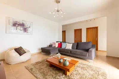 a living room with a couch and a coffee table at The Blue Pearl-Villa Paul in Calheta