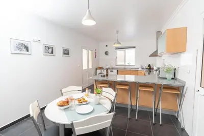 a kitchen and dining room with a table and chairs at The Blue Pearl-Villa Paul in Calheta