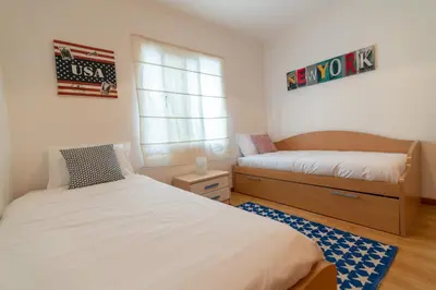 a bedroom with two beds and a window at The Blue Pearl-Villa Paul in Calheta