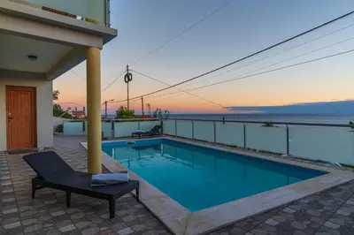 a swimming pool on top of a building with the ocean at The Blue Pearl-Villa Paul in Calheta