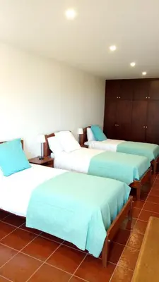 a group of four beds in a room at Vivenda Cabral in Funchal