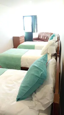 a group of three beds in a room at Vivenda Cabral in Funchal