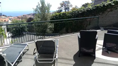 a group of chairs sitting on a balcony at Vivenda Cabral in Funchal