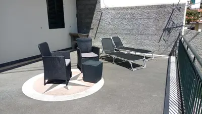 a group of chairs sitting on a balcony at Vivenda Cabral in Funchal