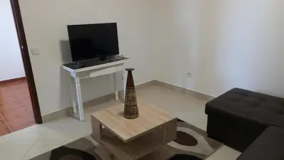 a living room with a couch and a television at Vivenda Cabral in Funchal