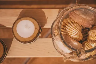 a table with shells and a candle on it at Slowing Villas - Villa Oceano in Porto Santo