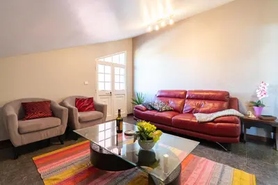 a living room with a couch and a table at Casa Por Do Sol in Ponta do Sol