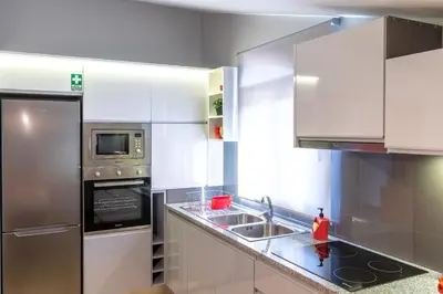 a kitchen with a sink and a microwave at Casa Por Do Sol in Ponta do Sol